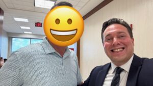 Two smiling men in a professional setting, one wearing a suit and the other in a patterned shirt, and David Smith of the David Smith Law Firm, celebrating recent DWI case dismissals.