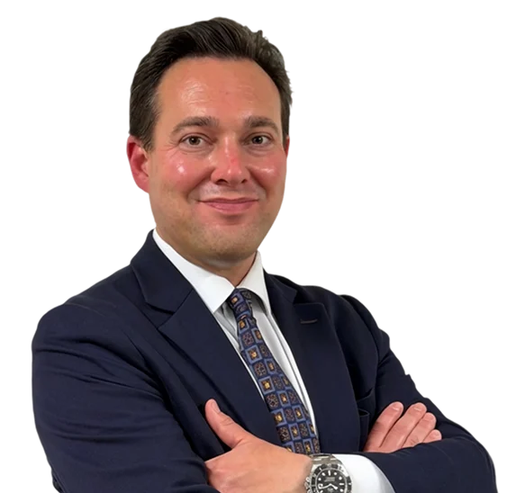 A man wearing a suit and tie smiling at the camera